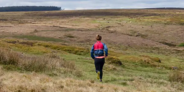 Female running through the hills of Derbyshire