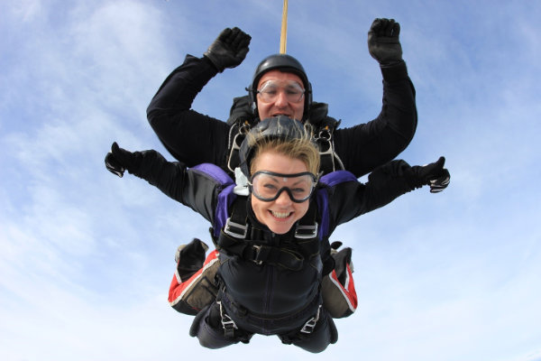 A person and person skydiving in a tandem skydive